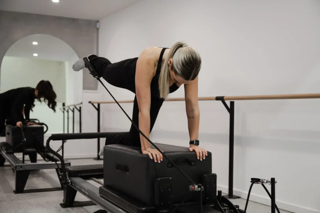 Megan Sullivan demonstrating Pilates leg exercises on a Pilates equipment