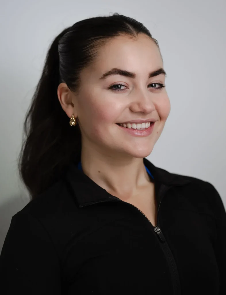 Renee Landcaster, APPI-qualified reformer pilates instructor at PIYO Studios with a warm smile