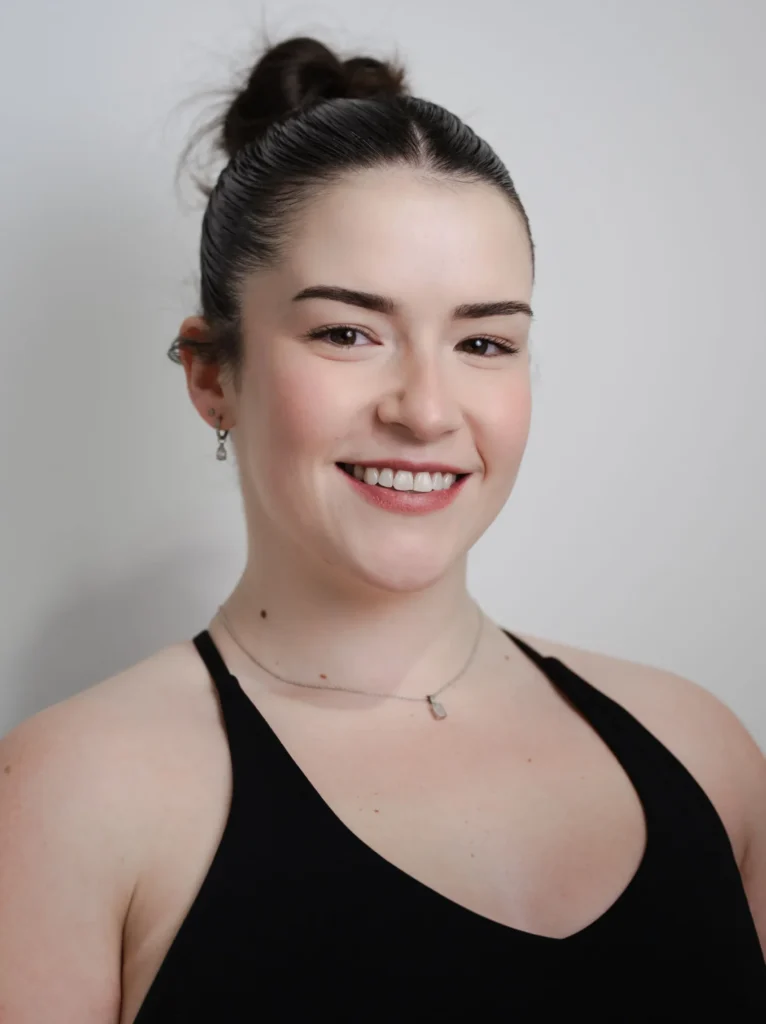 Kira Mitchell, reformer pilates instructor with a gentle smile