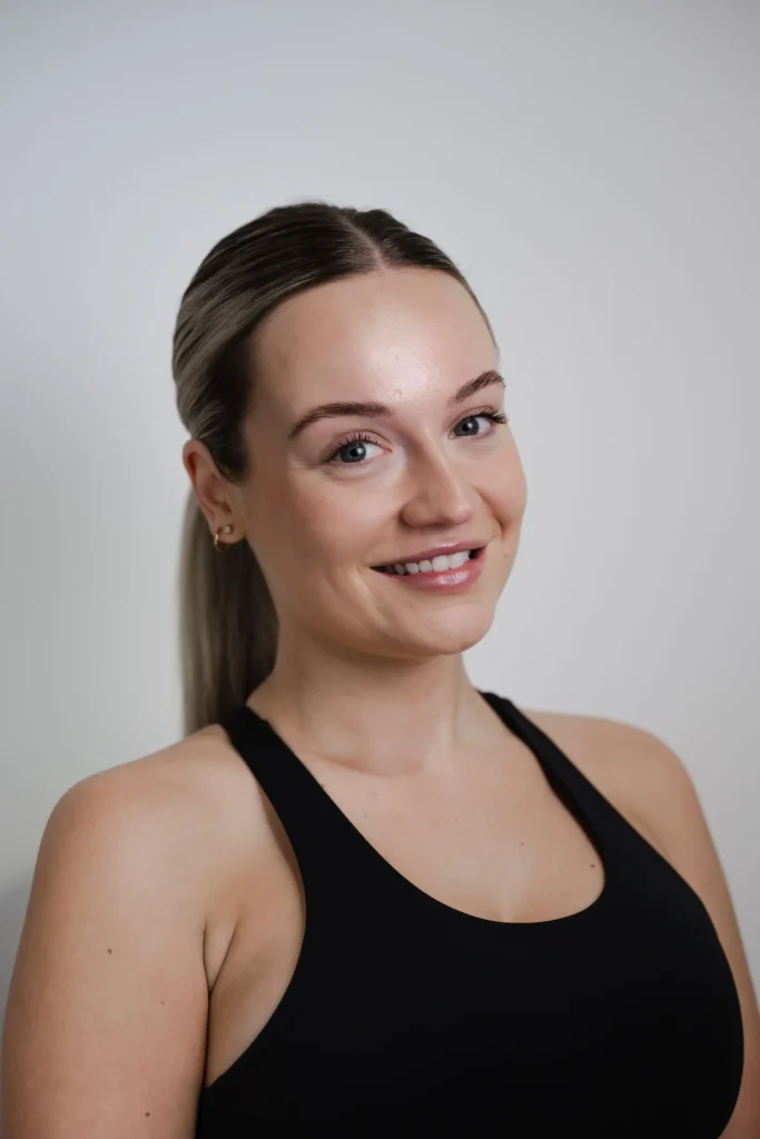 Megan Sullivan, reformer pilates instructor with a calm, friendly expression