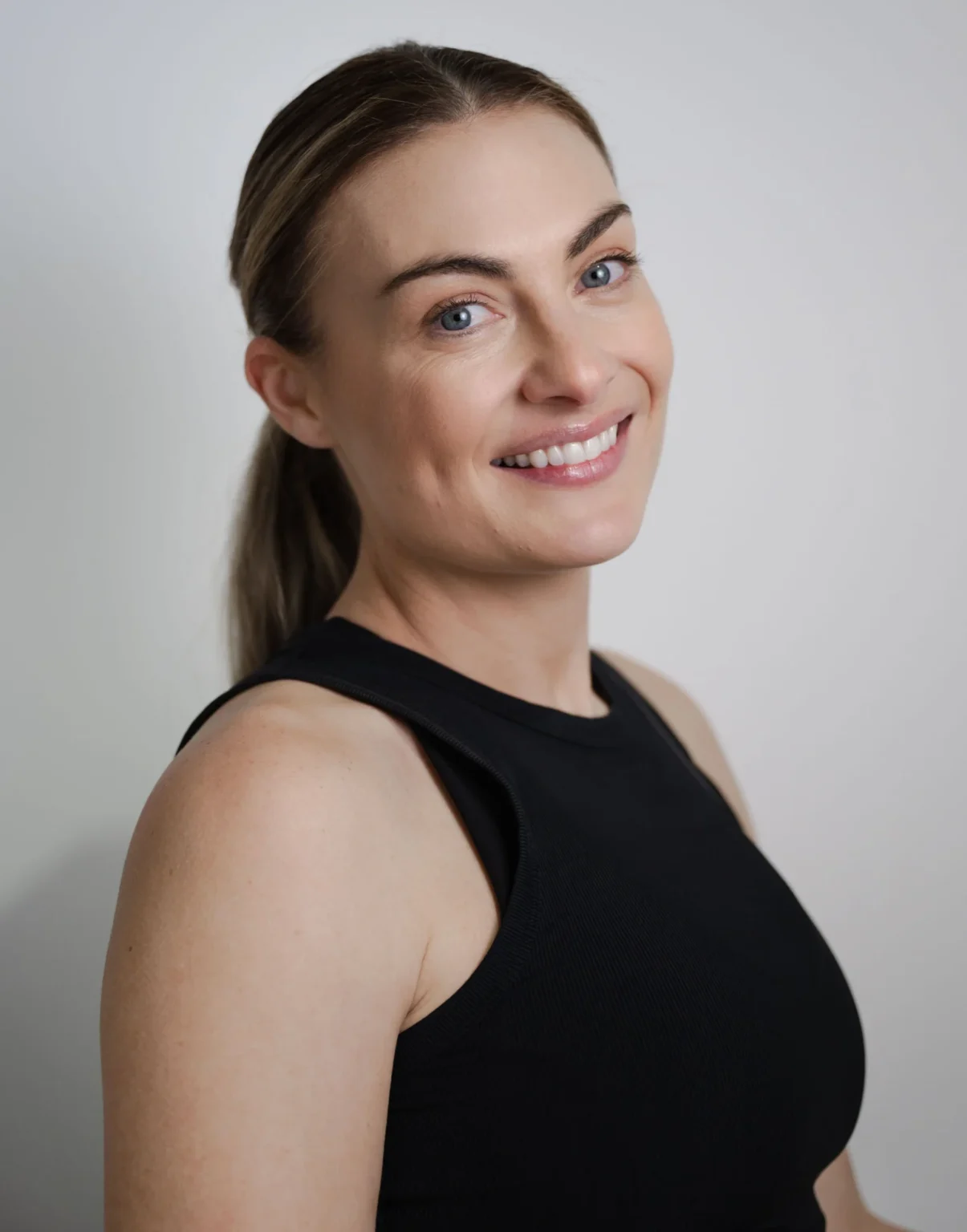 Alyce Doran, head reformer pilates instructor, smiling confidently at the camera