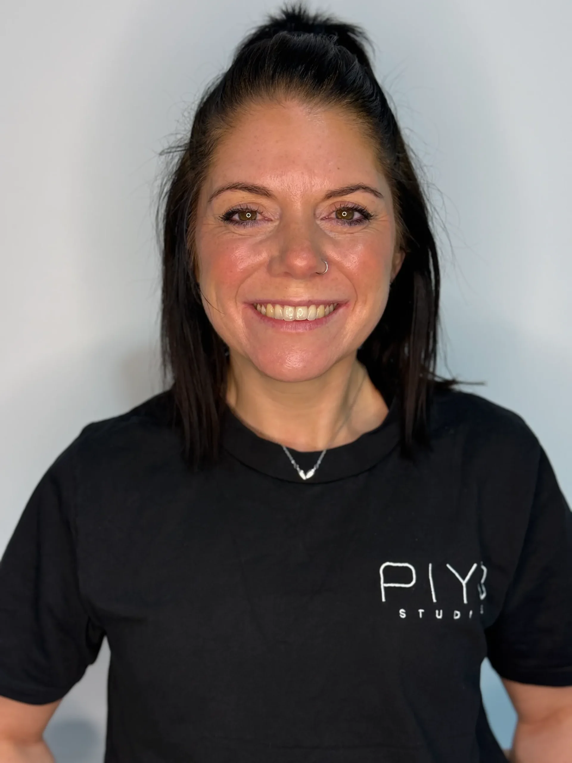 Vicky Hogan, certified reformer pilates instructor at PIYO Studios with a confident, welcoming smile